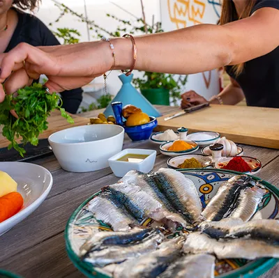 Small group cooking together on Marcooking rooftop in Essaouira